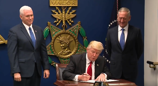 Trump signing order January 27.png