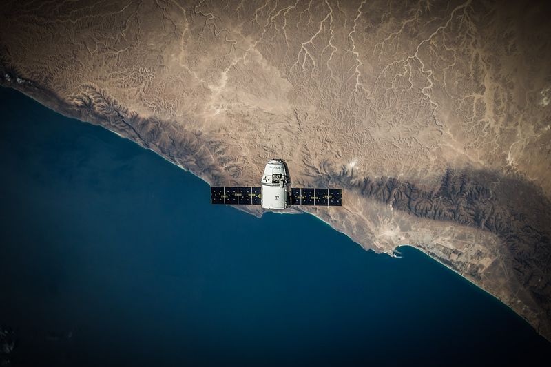 File:Satellite above earth.jpeg