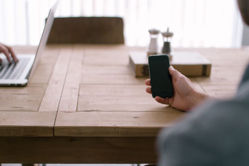 File:Person-smartphone-office-table.jpeg