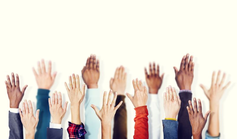 File:Multiple people raising hands.jpg