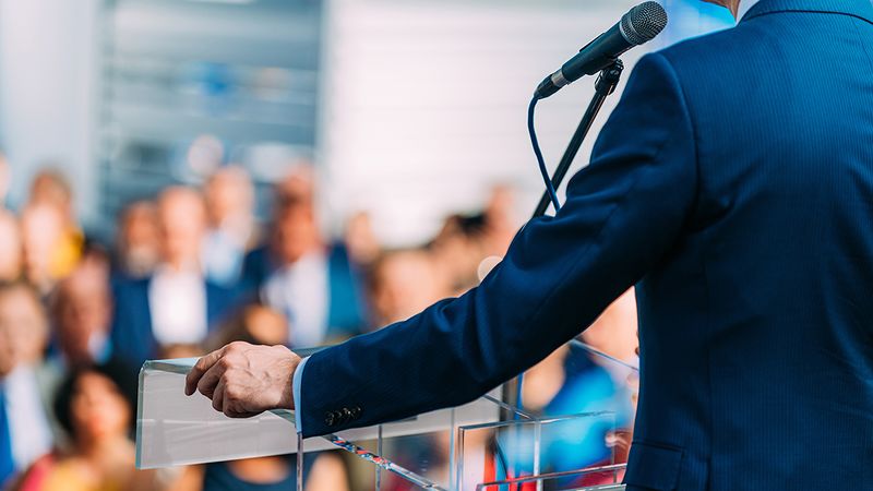 File:Campaign speaker with blurred crowd.jpg